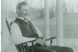 Philip T. Oatfield on porch ca. 1903 - enhanced